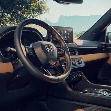 2027 Honda Passport TrailSport Elite steering wheel and dashboard with touchscreen infotainment (Mid-Size SUV).